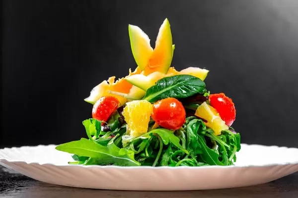 Vegetarian salad with herbs and avocado on white plate (Flip 2019)