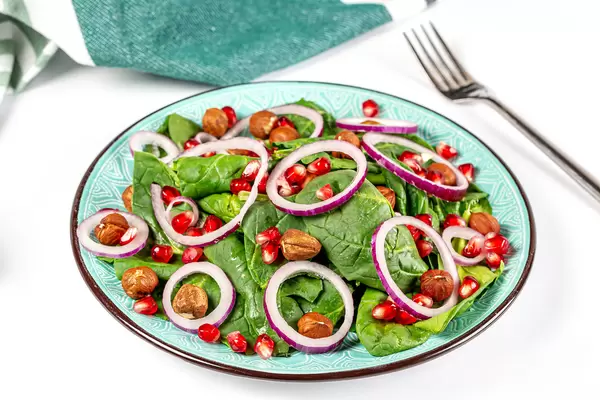 Vegetarian salad with spinach and hazelnuts