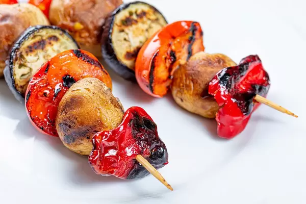 Vegetarian shashlik on a wooden skewer of vegetables