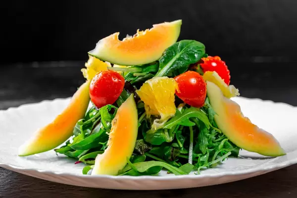 Vegetarischer Salat mit Kirschtomaten, Orangen, Avocado und frischen Kräutern