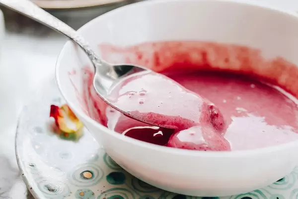 Veggie breakfast with strawberry smoothie in a white bowl