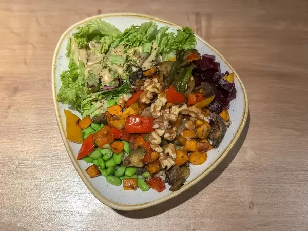 Veggie Buddha Bowl with grilled vegetables, paprika, Edamame, nuts, beetroot, wholemeal rice, soy sesame sauce and fresh basil
