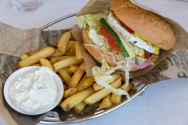 Veggie burger by Bus Burger Restaurant in Lahti, with goat cheese, sun-dried tomatoes, lettuce devil's jam, mustard, mayonnaise, pickles, fries and dip
