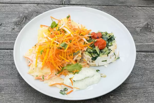 Veggie dish: fried goat cheese with rapini, pumpkin seeds and tomato concasse with carrot-potato gratin and small mixed salad