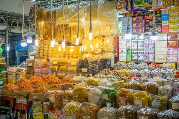 Vendor at Ben Thanh Market in Saigon offering a variety of Snacks