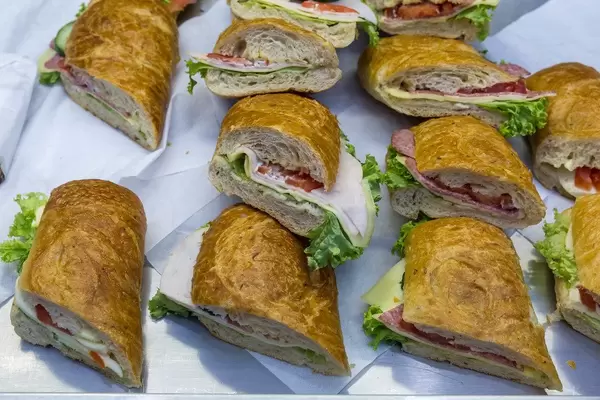 Verschiedene belegte Baguette Stücke mit Wurst, Käse und Salat