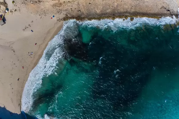 Very few people on the beach of Cala Torta in Mallorca near Artà in summer 2020. Aerial view