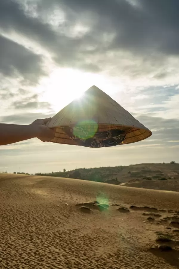 Vietnamese Hat in front of the Sunset in the Red Sand Dunes in Mui Ne  Flip 2019