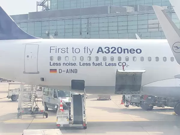 View from an airplane window onto Frankfurt Airport and the Airbus A320neo by Lufthansa, withith baggage conveyor to the cargo hold