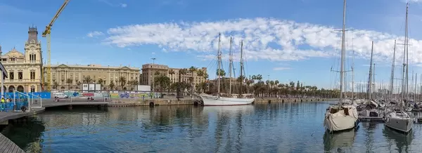 View from the wooden walkway of Rambla de Mar to the Port Vell  with its sailboats and yachts in Barcelona, on the east coast of Spain.
