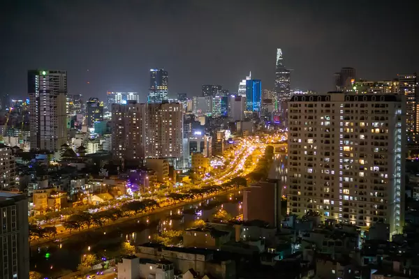 View of Busy Highway in District 1 and City Center with Bitexco Financial Tower at Night in Ho Chi Minh City, Vietnam