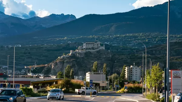 View of Château de Tourbillon up on the hill from the Swiss road