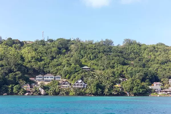 View of resorts among palm trees facing the Indian Ocean in Mahé, Seychelles
