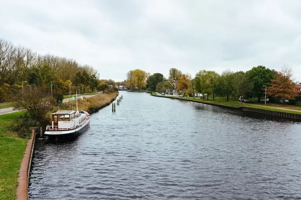 View of the Dutch canal with windmill near De Nieuwe Noorder park