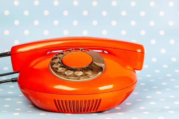 Vintage red telephone on blue background