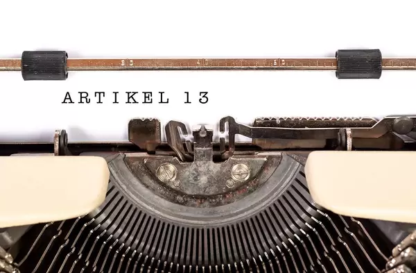 Vintage typewriter from above and written "Artikel 13" as a symbol for the debate about copyrights in the EU