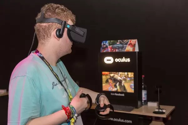 Visitor playing MARVEL Powers United VR Oculus Rift Headset and Touch Controller
