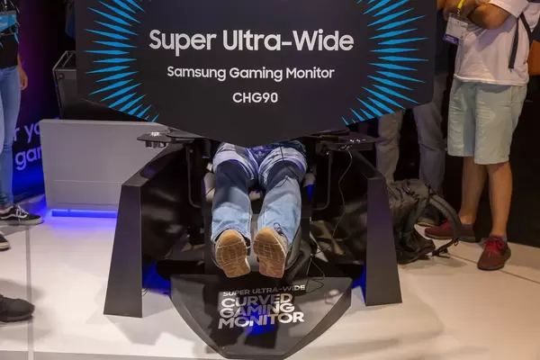 Visitor trying out the new super ultra-wide gaming monitor Samsung CHG90