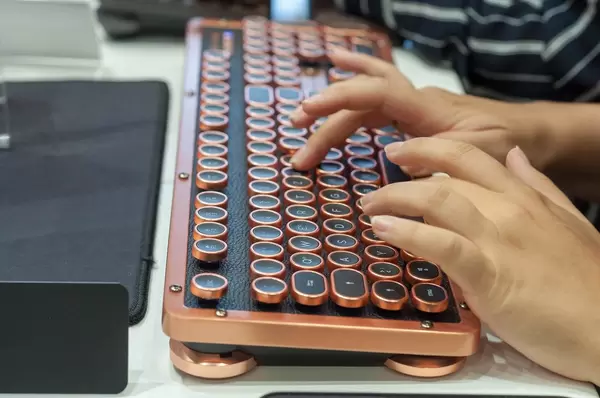 Visitor typing on an Azio Retro Classic keyboard