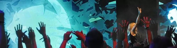 Visitors raising their hands to catch give-aways at the Gamescom fair in Cologne, Germany