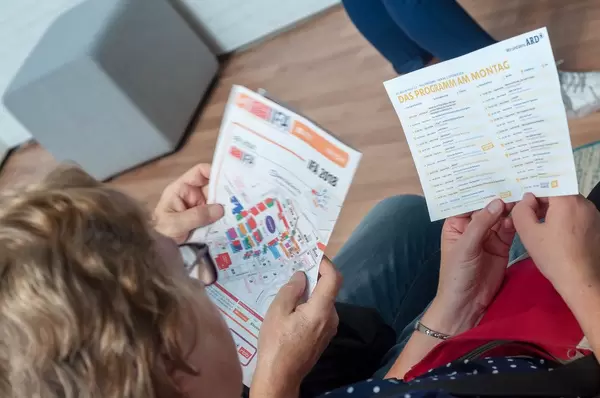 Visitors studying the hall plan and schedule of IFA 2018