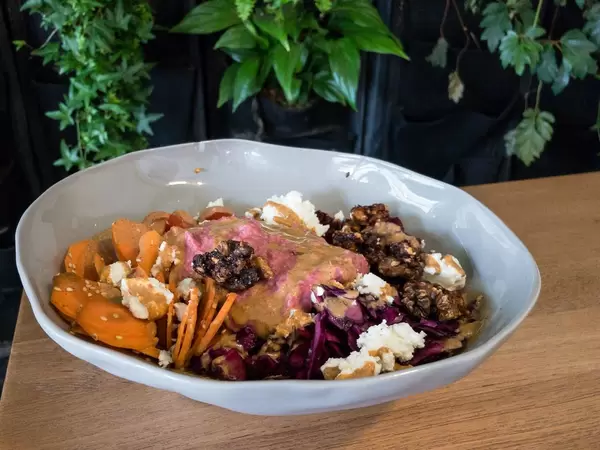 Vollkornreis, Rote Beete, Sesam-Möhren, eingelegter Rotkohl, Kirschtomaten, geröstete Walnüsse, Schafskäse, Rote Beete-Hummus, würziges Tahini-Dressing