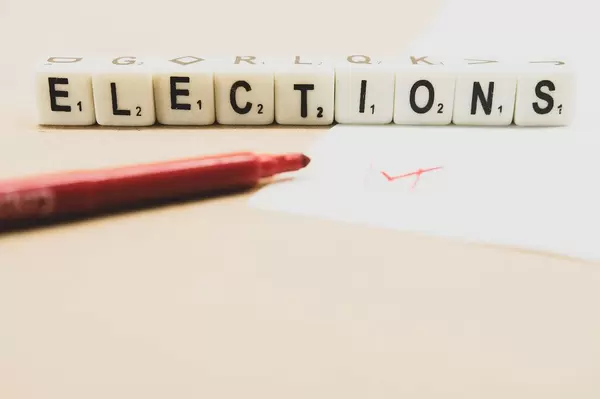 Voting paper with dice reading ELECTIONS