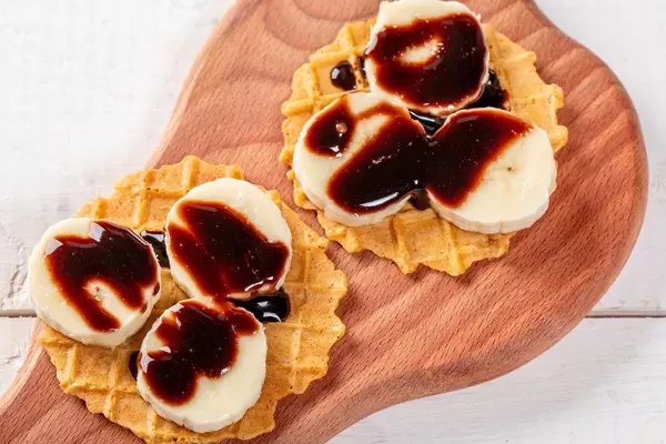 Waffeln mit frischen Bananen und Schokoladensauce als Topping