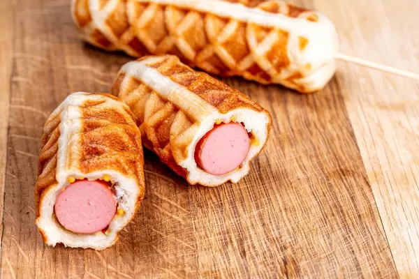 Waffle sausages on a wooden kitchen board