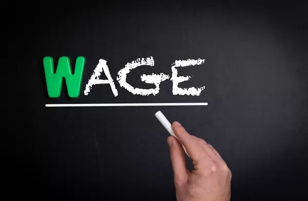 Wage text on blackboard