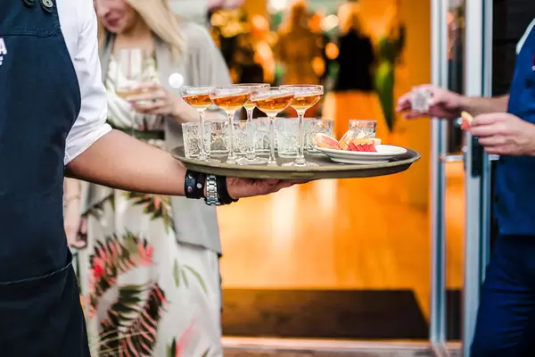 Waitress Serving Set Of Vodka And Cognac