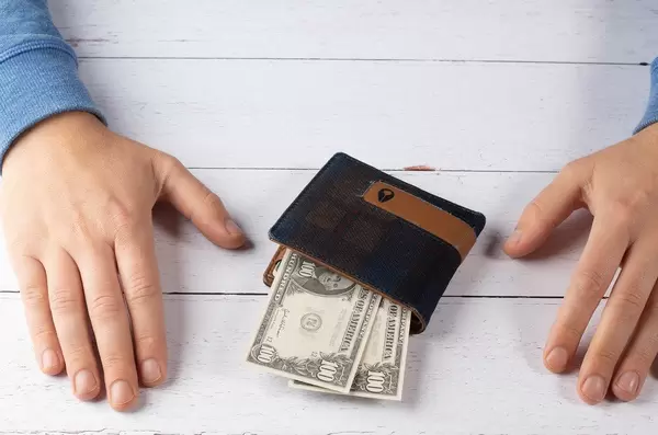 Wallet and hands on white table