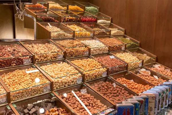 Walnüsse, Macadamia- und Cashewnüsse zum Selbstabfüllen in der überdachten Markthalle Mercat de la Boqueria in Barcelona, Spanien