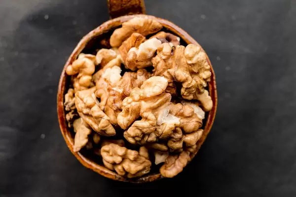 Walnuts in a ceramic cup , top view