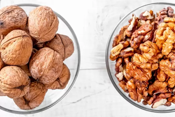 Walnuts on white wooden background