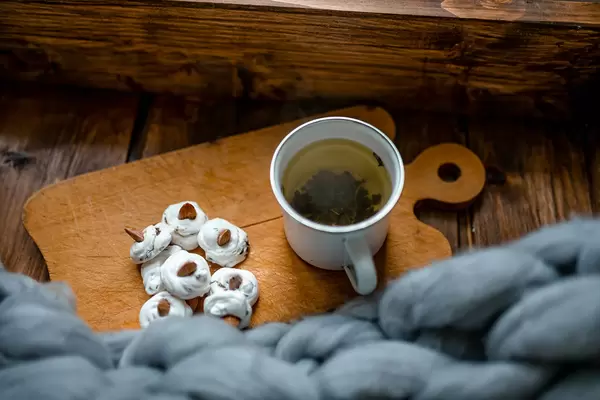 Warm Green Tea With Meringues Beze Cookies On Rustic Set.jpg