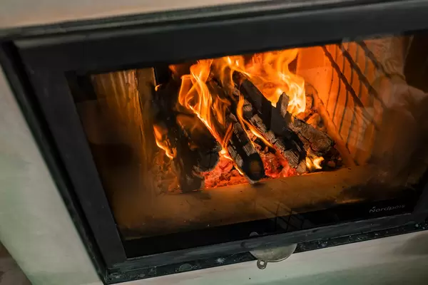 Warm Light From Flames In Fireplace With Wood
