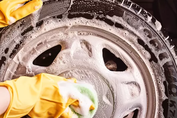 Washing car tires with a sponge