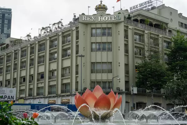 Water Fountain with Pink Lotus Flower with Iconic and Luxury Rex Hotel in the Background in Ho Chi Minh City, Vietnam