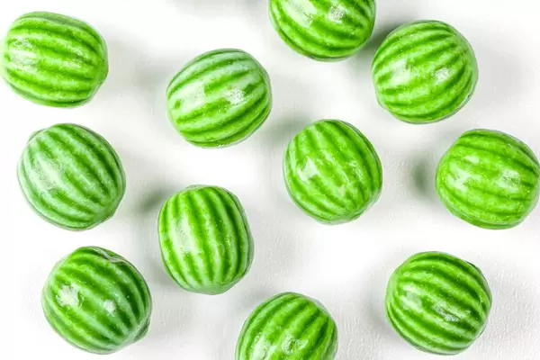 Watermelon chewing candy on a white background, top view (Flip 2020)