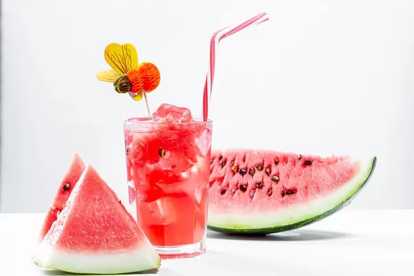 Watermelon drink in glass with slices of watermelon