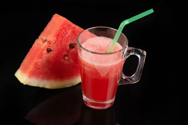 Watermelon Juice above black reflective background