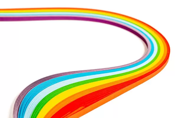 Wavy rainbow made from colored paper on white