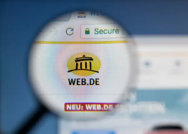 Web.de logo on a computer screen with a magnifying glass