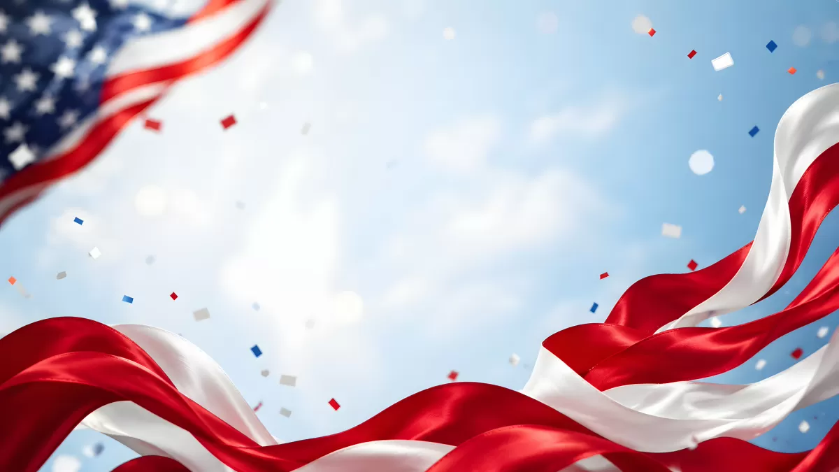 Wehende US-Flagge mit Konfetti vor blauem Himmel