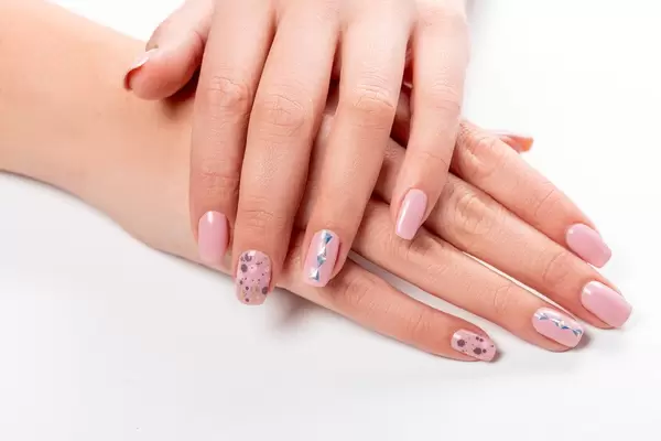 Well-groomed female hands with manicure on a white background (Flip 2020)