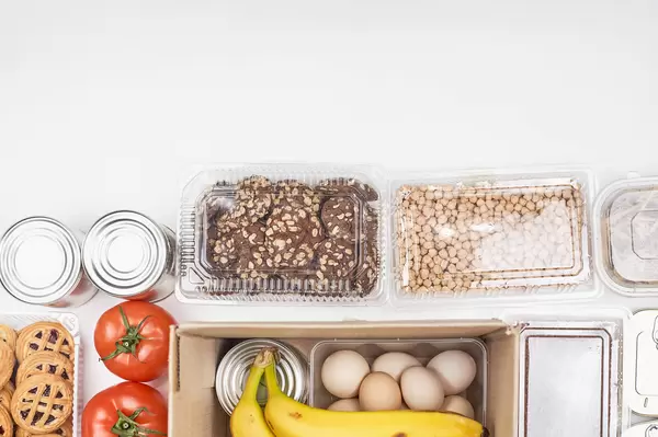 White background with food supplies and space for text at the top. Donations to prevent hunger