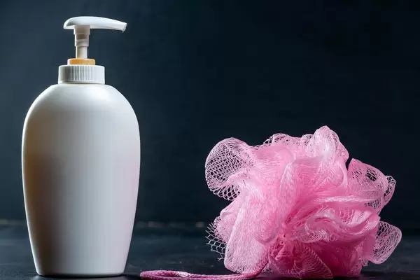 White bottle with shower gel and washcloth