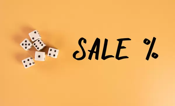 White dices with Sale % text on orange background