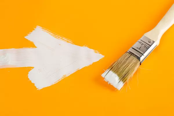 White drawn arrow on orange background